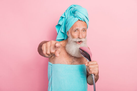 Photo of funky retired man sing shower head in bath point finger in camera isolated on pastel color background
