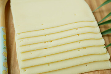 stack of slices of cheese on yellow close up  - Powered by Adobe