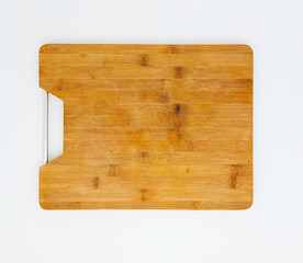 Used wooden cutting board with metal handle, isolated on white background. Top view, flat lay.