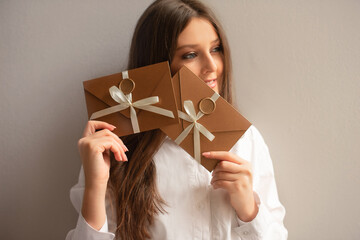 excited girl happy to take bronze envelope with gift certificate or voucher