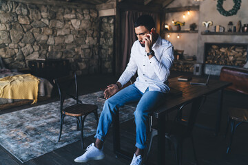 Ethnic man having conversation on smartphone