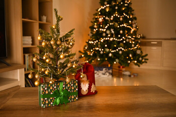 Many Christmas presents on floor in room at night