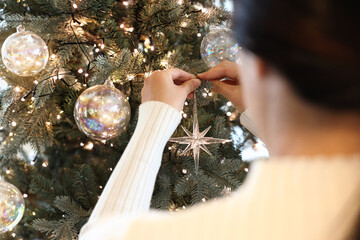 woman decorating the christmas tree