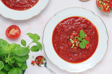 Plates with traditional gazpacho tomato soup