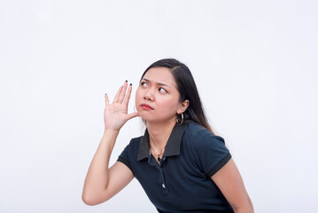 A snoopy young woman eavesdropping on a private conversation. Bending to the left, hands on her...