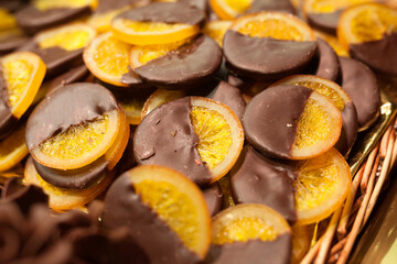 slices of orange in chocolode on counter