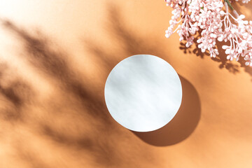 Empty white circle mockup podium for product presentation on a blooming spring flower background...