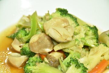 stir fried slice broccoli and carrot with straw mushroom on plate   