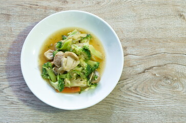 stir fried slice broccoli and carrot with straw mushroom on plate   