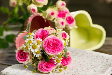 Heart bowls with roses on a wooden garden table