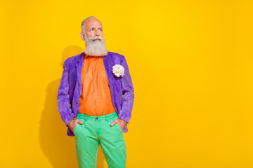 Photo portrait of attractive granddad confident look empty space chill dressed stylish colorful outfit isolated on yellow color background