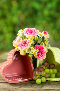 Heart bowls with roses on a wooden garden table