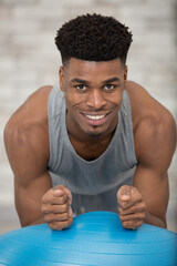 muscular man training on an aerobic ball