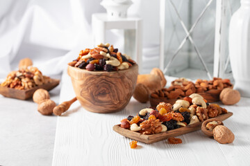 Naklejka na ściany i meble Mix of nuts and raisins on a white wooden table.