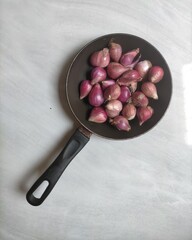 Onion in frying pan white background 