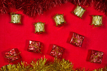 Concept of christmas and new year. Christmas toys and tinsel on a red background. christmas...