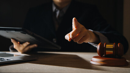 Business and lawyers discussing contract papers with brass scale on desk in office. Law, legal services, advice, justice and law concept picture with film grain effect