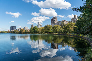 Fototapeta na wymiar Corner view of Central Park, city center park, sky reflected on lake in park in Isle of Manhunt, New York