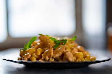 pasta with chicken meat, cream sauce and cheese in a plate