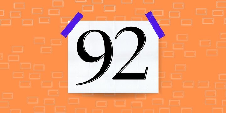Number 92. Banner with the number ninety two on a orange background and white square with blue stickers