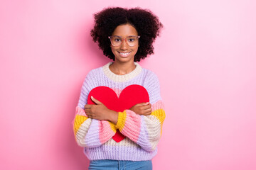 Photo of cute youngster positive schoolgirl dress knitwear hug red paper heart first college love isolated on bright pink color background