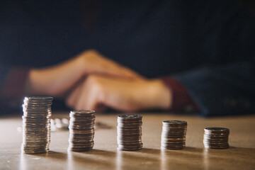 businessman holding coins putting in glass. concept saving money for finance accounting