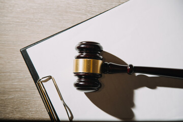 Justice and law concept.Male judge in a courtroom with the gavel, working with, computer and...