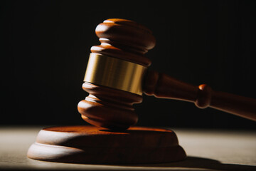 Justice and law concept.Male judge in a courtroom with the gavel, working with, computer and...