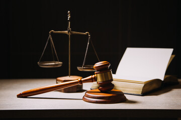 Justice and law concept.Male judge in a courtroom with the gavel, working with, computer and docking keyboard, eyeglasses, on table in morning light