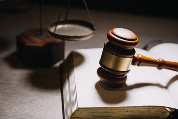 Justice and law concept.Male judge in a courtroom with the gavel, working with, computer and...