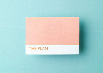 The Blank adhesive sticky note on a green cardboard background with copy space for your text or message.