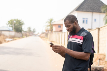 african man using his phone outside