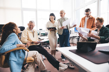 Positive businesspeople brainstorming startup in office building