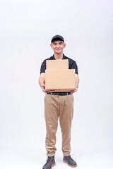 A handsome asian delivery man, carrying two boxes. A courier handling and delivering parcels. Isolated on a white background.