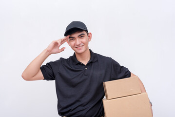 A dependable male courier, carrying two boxes while giving a salute. Isolated on a white background.