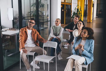 Group of diverse colleagues listening to presentation in office