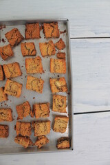 a bunch of dried chocolate banana sponge slices in a baking dish on the table