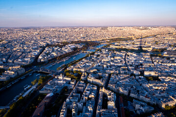 Obraz premium Photo of paris rooftops and Seine from Eiffel tower during spring sunset.