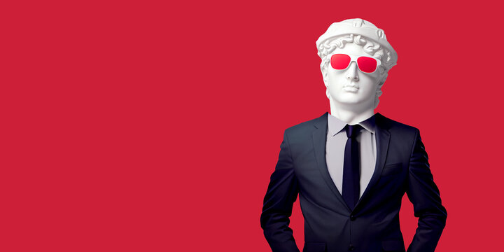 Antique male statue's head in red sunglasses showing with suite isolated on a red banner background. Trendy collage in magazine surreal style. 3d contemporary art. Modern design.fashion art collage.