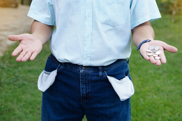 Closeup man wears jeans, turning out  pockets to show empty pocket. Make hands gesture to show few...