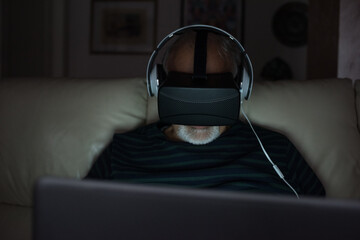 Senior adult man indoors using 3d goggles