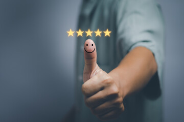 customer service concept and satisfaction survey, man thumbs up with smiley face icon showing satisfaction, support, quality assessment or impressive service of business