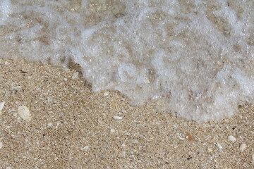 Stone,sand,sea water and beach with lighting in the morning:Close up,select focus with shallow depth of field:ideal use for background.