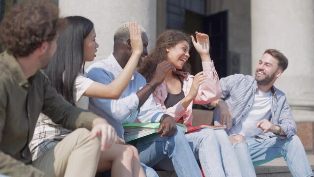 student and coed giving each other a friendly high five.