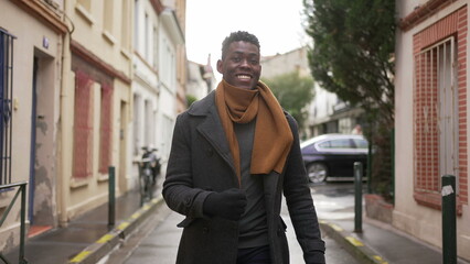 Fototapeta premium Happy black man celebrating success while walking outside in street