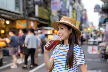 Woman drink with iced tea in the street