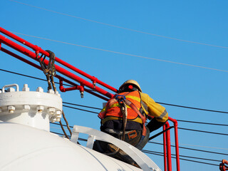 Man Working on the Working at height on construction site with blue sky