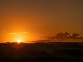 Dramatic sunrise sky with clouds in North Devon, England.