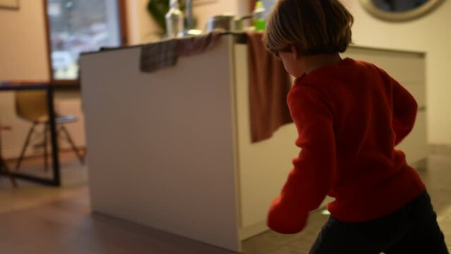 One happy child running at modern home living room. Excited little boy runner indoors in slow motion