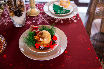 Christmas mood, holiday atmosphere. Festive table decor on a wooden veranda.